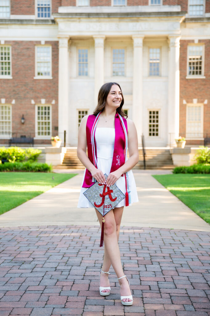 Bama grad holds customized grad cap at her graduation photoshoot 
