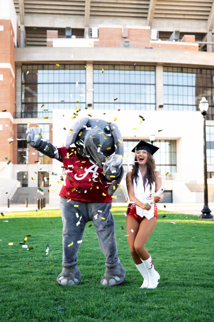 Big Al and a Crimsonette pop confetti near Bryant Denny Stadium